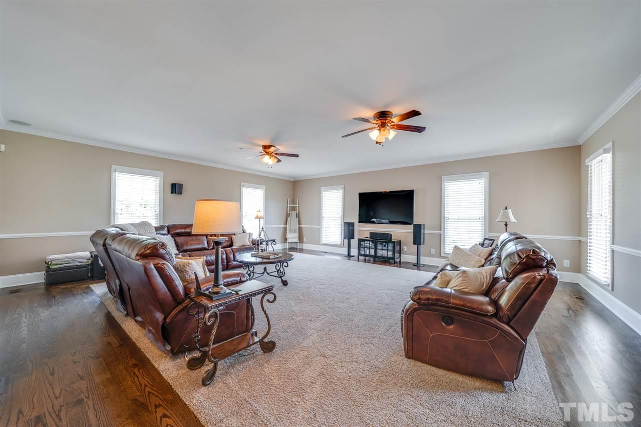 2256 Sanders Road Stem, NC 27581 - Photo 17 of 29 a living room with furniture and a flat screen tv