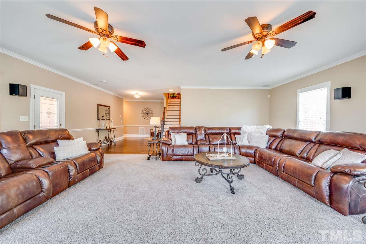 2256 Sanders Road Stem, NC 27581 - Photo 18 of 29 a living room with furniture ceiling fan and a window