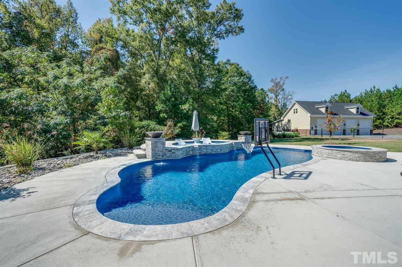 2256 Sanders Road Stem, NC 27581 - Photo 25 of 29 a view of a swimming pool with a yard