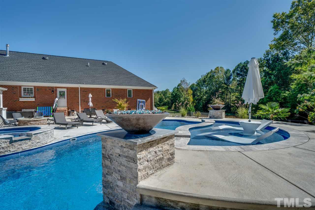 2256 Sanders Road Stem, NC 27581 - Photo 26 of 29 a view of a backyard with plants and patio