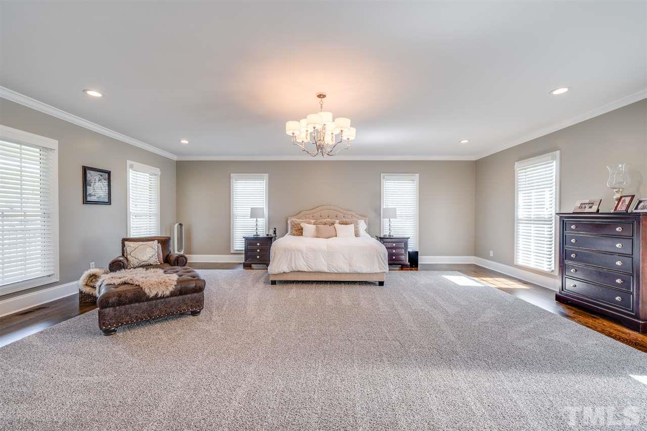 2256 Sanders Road Stem, NC 27581 - Photo 8 of 29 a spacious bedroom with a bed and a couch