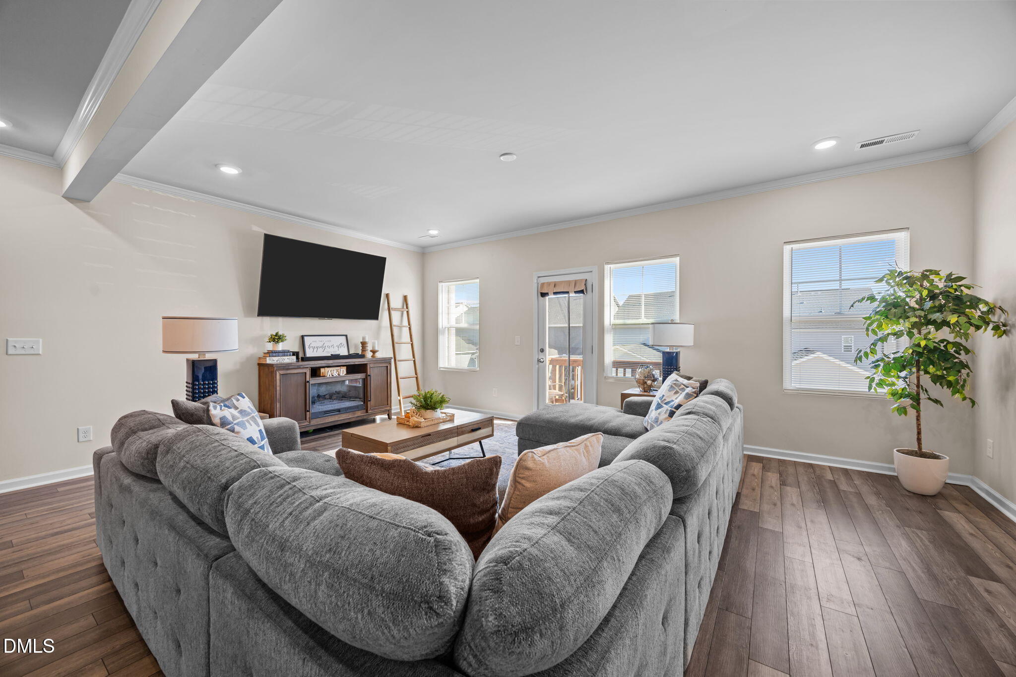6414 Nurture Avenue Raleigh, NC 27616 - Photo 12 of 36 a living room with furniture a flat screen tv and a fireplace