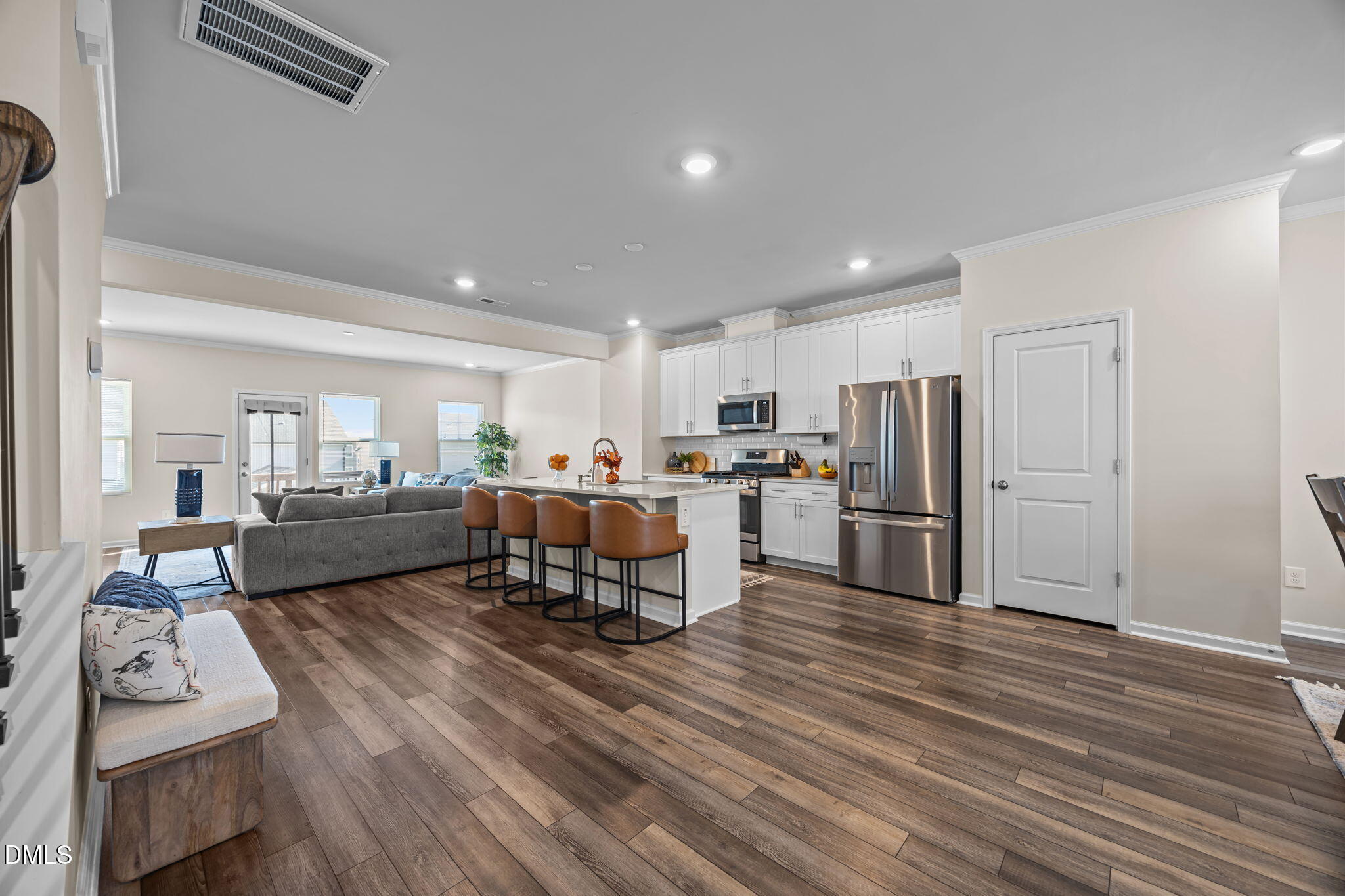 6414 Nurture Avenue Raleigh, NC 27616 - Photo 19 of 36 a living room with stainless steel appliances furniture wooden floor and a kitchen view