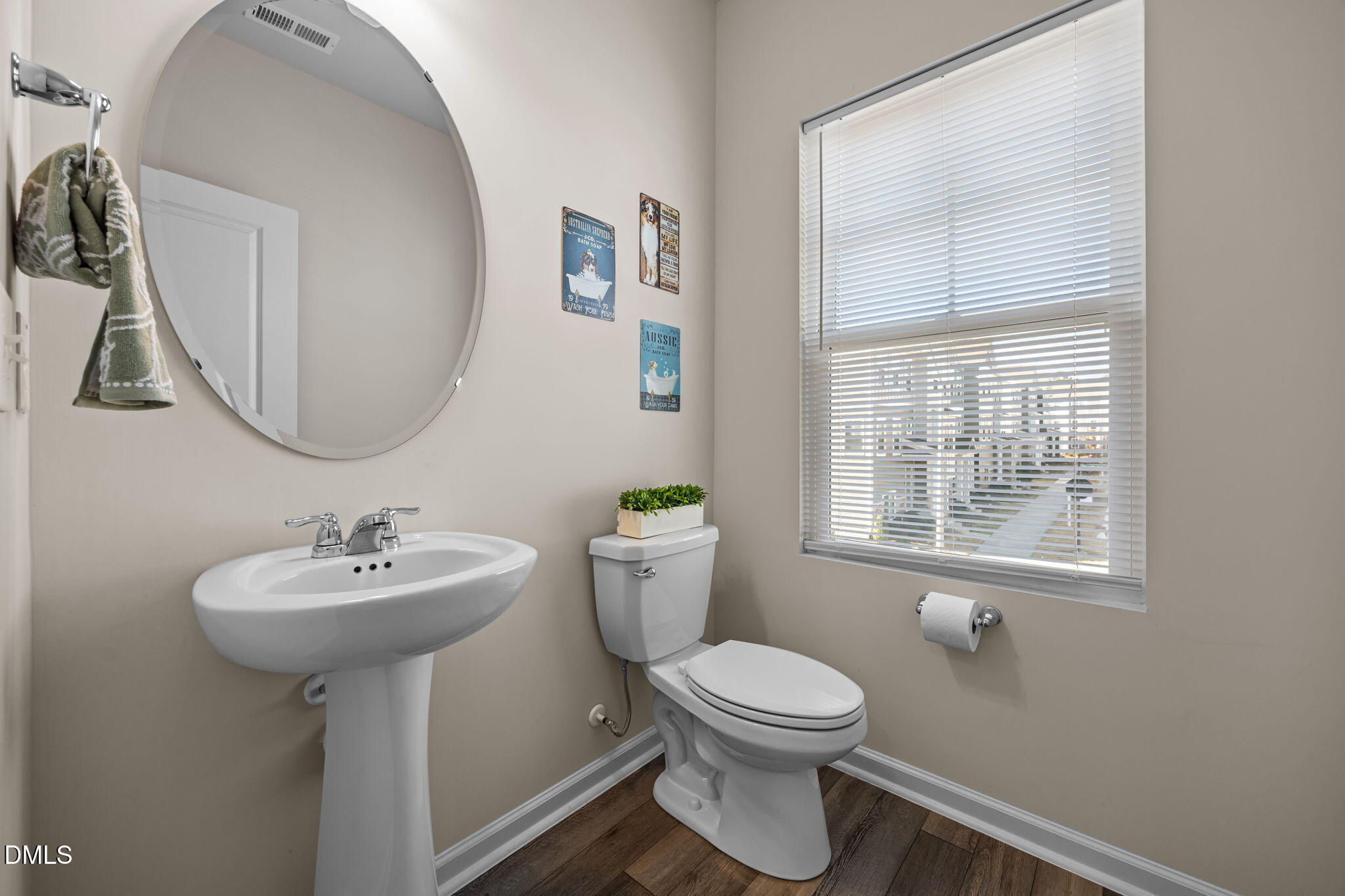 6414 Nurture Avenue Raleigh, NC 27616 - Photo 20 of 36 a bathroom with a sink toilet and a mirror