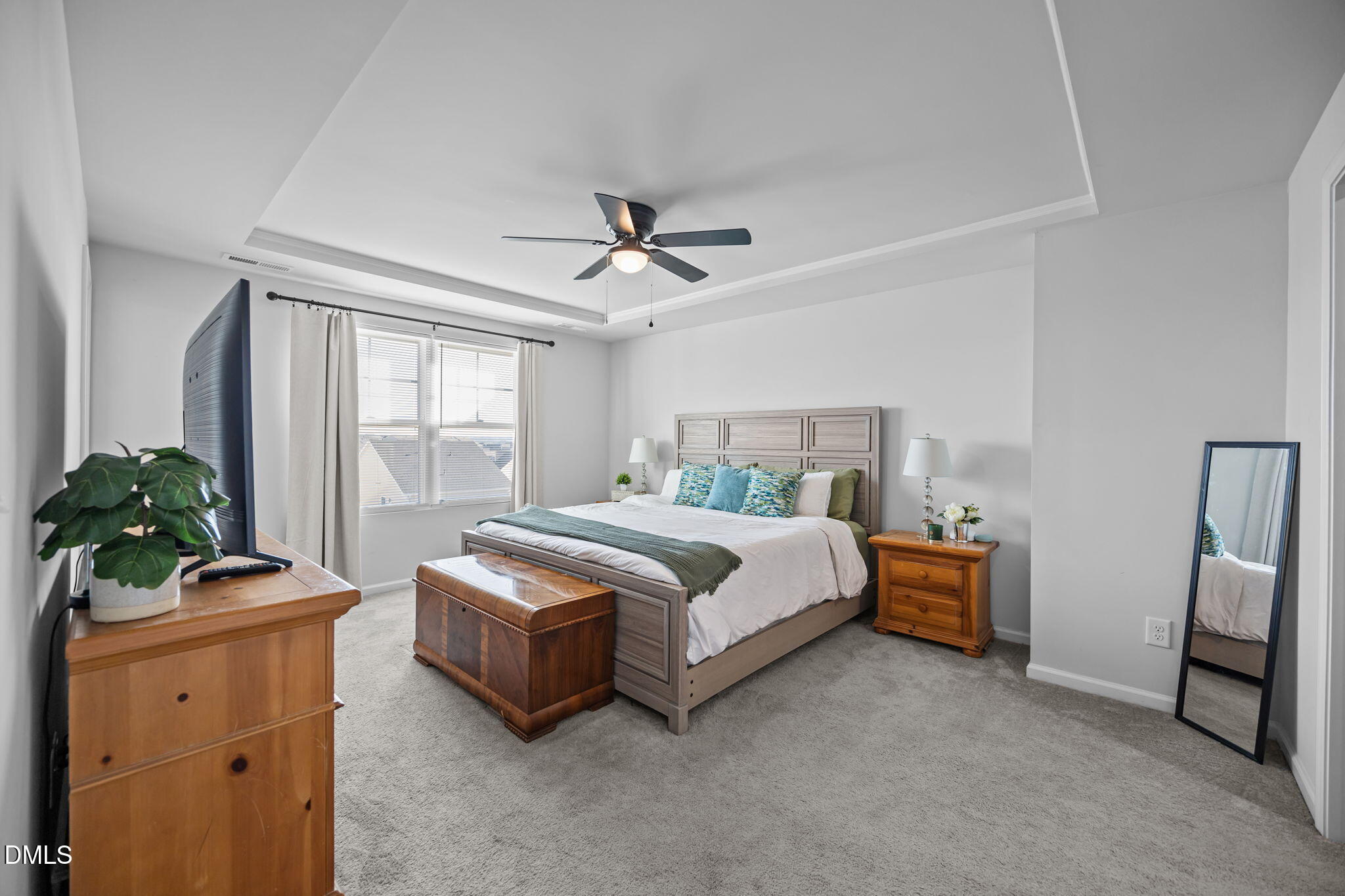 6414 Nurture Avenue Raleigh, NC 27616 - Photo 21 of 36 a bedroom with a bed and a potted plant