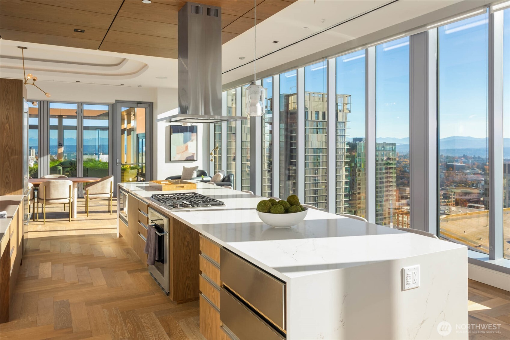 a kitchen with a stove and a view of living room