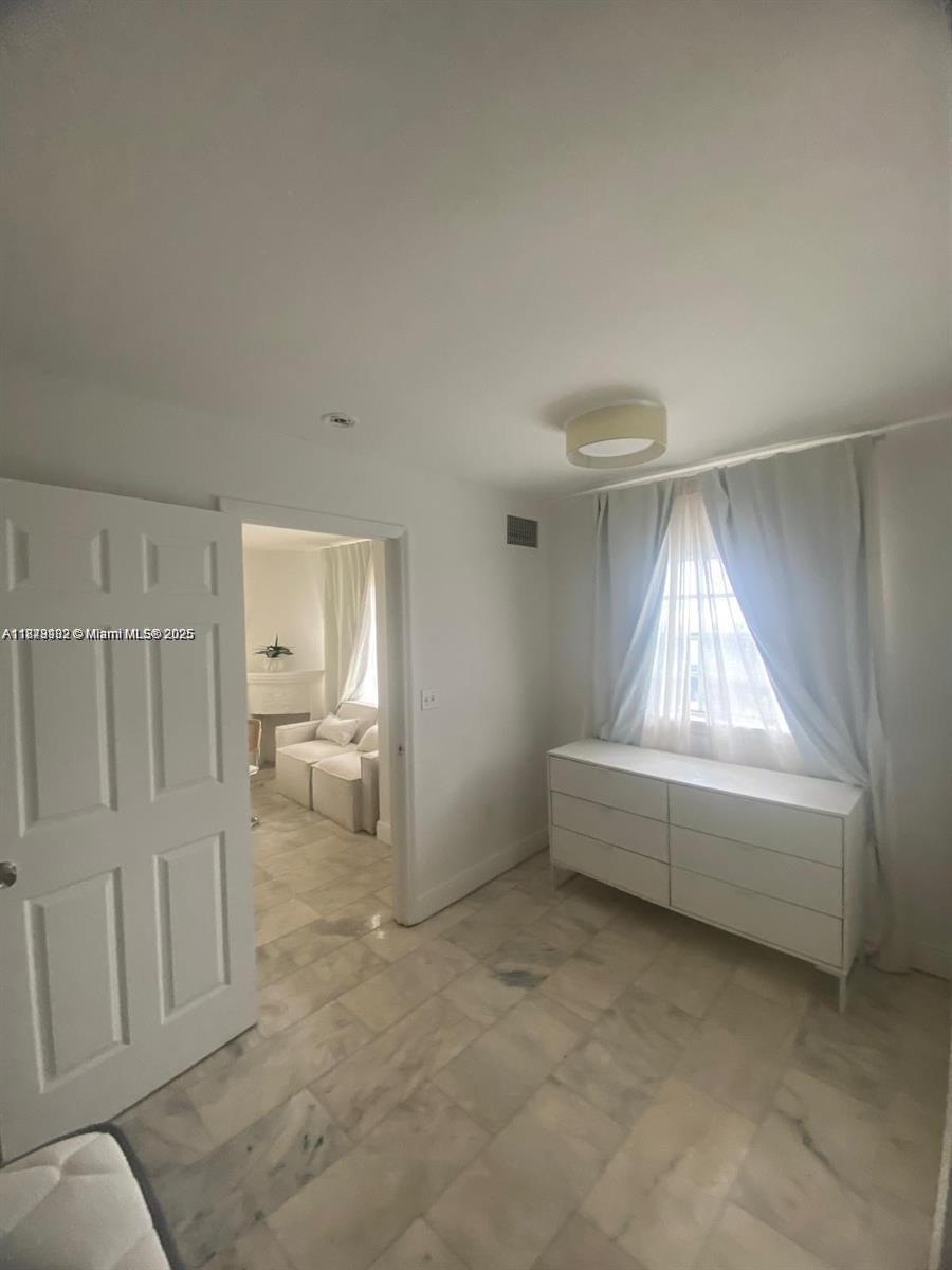 1526 Pennsylvania Avenue, Unit 10 Miami Beach, FL 33139 - Photo 2 of 6 a living room with furniture and a fireplace