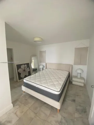 a bed sitting in a bedroom and table