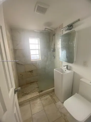 a bathroom with a toilet and shower