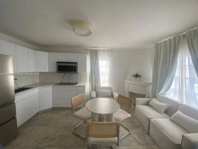 a kitchen with stainless steel appliances granite countertop a sink and a refrigerator