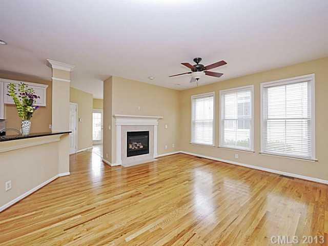 420 Third Baxter Street Fort Mill, SC 29708 - Photo 5 of 16 an empty room with wooden floor a ceiling fan and windows