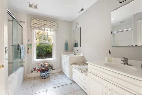 a bathroom with a sink mirror and a bathtub