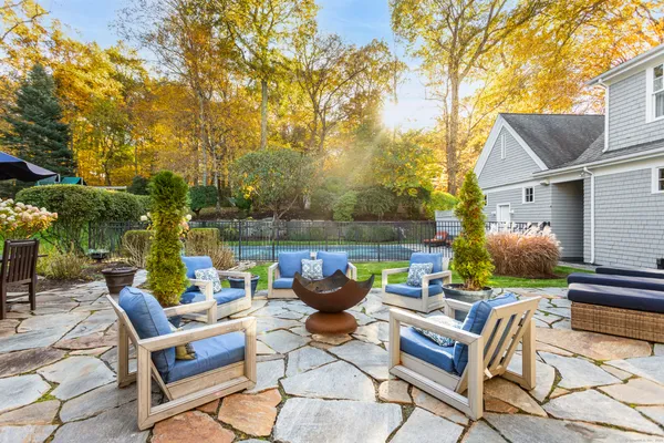 a view of a patio with couches table and chairs and potted plants