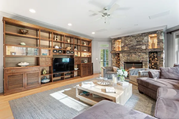 a living room with furniture a flat screen tv and a fireplace