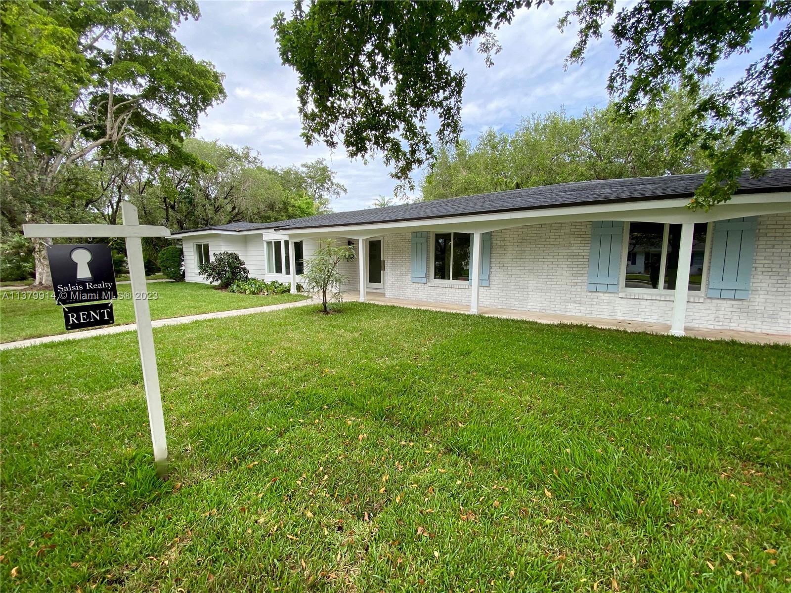 a view of a house with a yard and sitting area