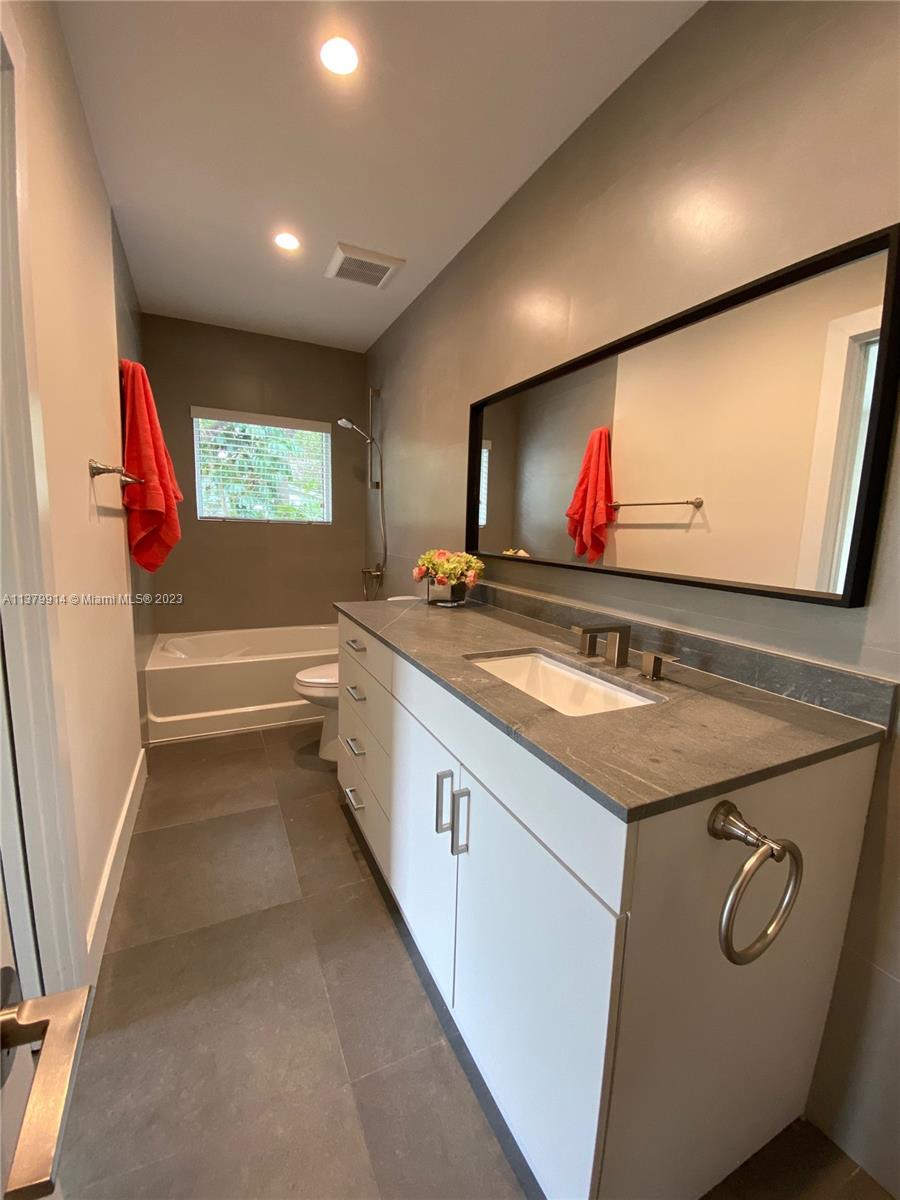 11821 Southwest 81st Road, Unit 11821 Pinecrest, FL 33156 - Photo 11 of 14 a kitchen with stainless steel appliances granite countertop a sink and a microwave