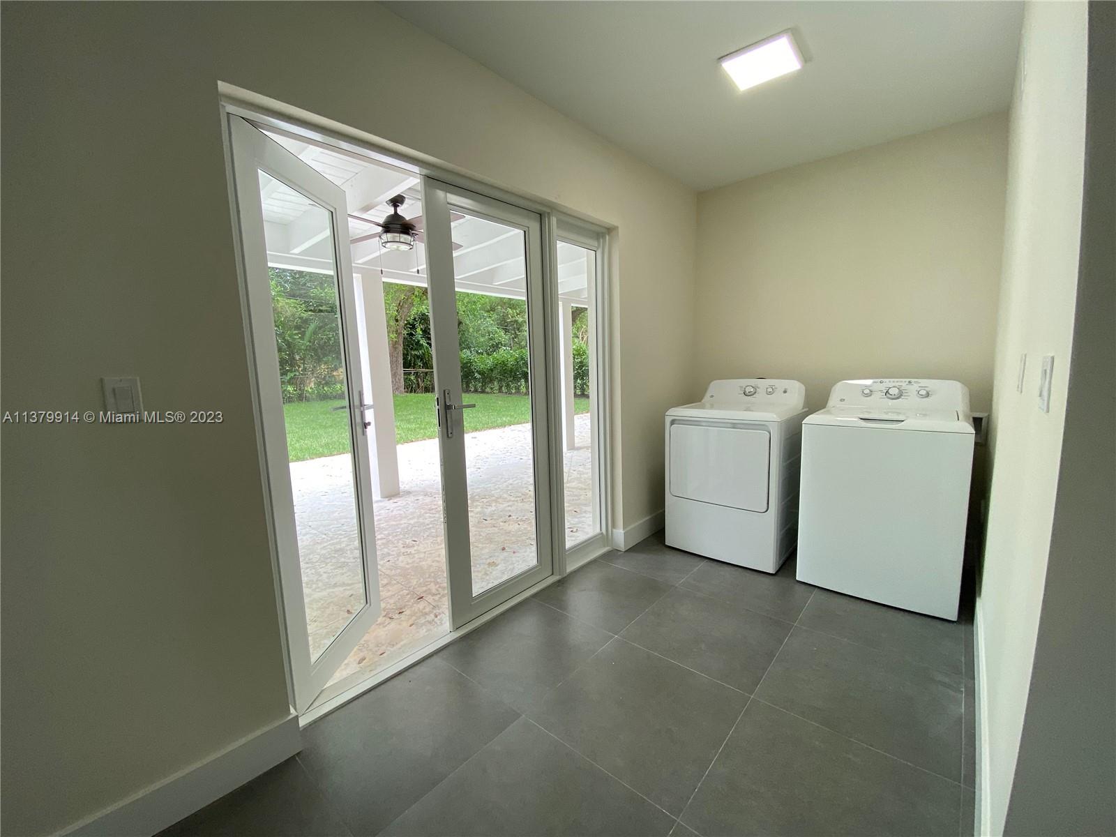 11821 Southwest 81st Road, Unit 11821 Pinecrest, FL 33156 - Photo 5 of 14 a utility room with dryer and washer