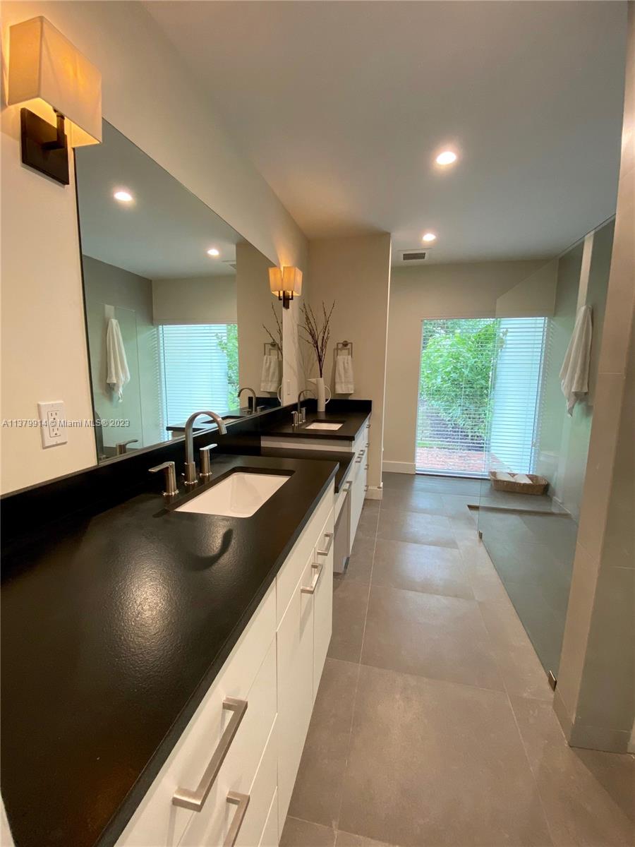 11821 Southwest 81st Road, Unit 11821 Pinecrest, FL 33156 - Photo 8 of 14 a kitchen with stainless steel appliances granite countertop a sink a stove and a wooden floors