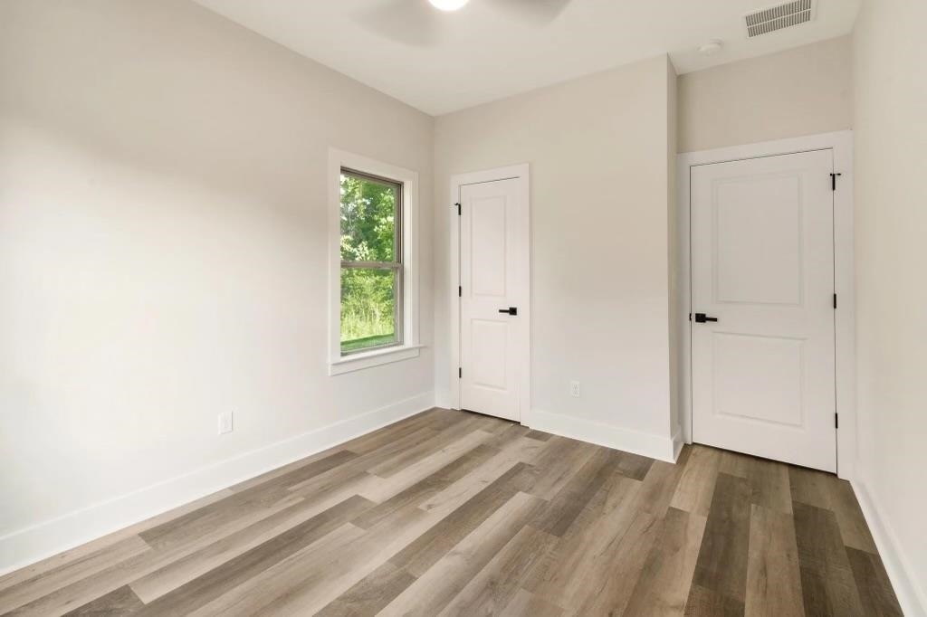 4977 Chevron Road Memphis, TN 38118 - Photo 11 of 19 a view of a bedroom with wooden floor and window