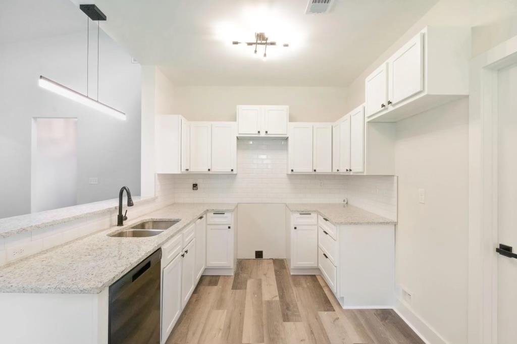 4977 Chevron Road Memphis, TN 38118 - Photo 3 of 19 a kitchen with granite countertop white cabinets and white appliances