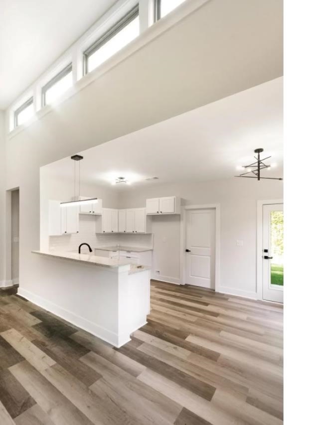 4977 Chevron Road Memphis, TN 38118 - Photo 4 of 19 a large white kitchen with kitchen island a sink stainless steel appliances and cabinets