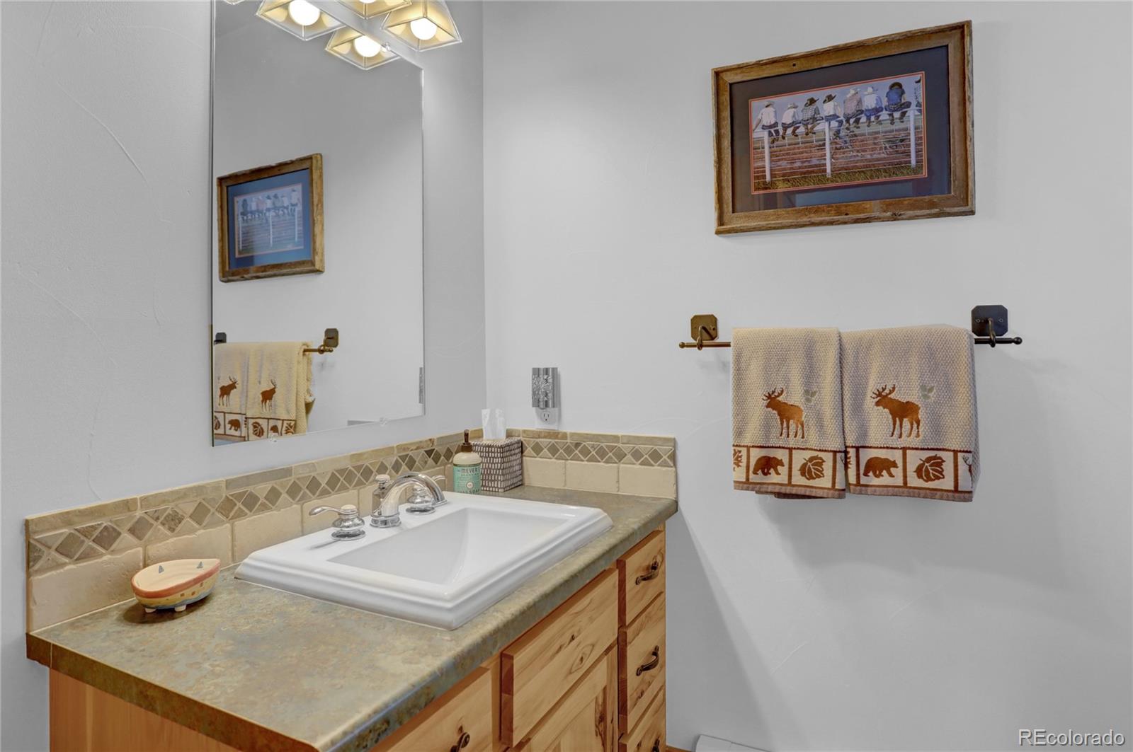 20 County Road 523 Tabernash, CO 80478 - Photo 15 of 32 a bathroom with a sink vanity and a mirror