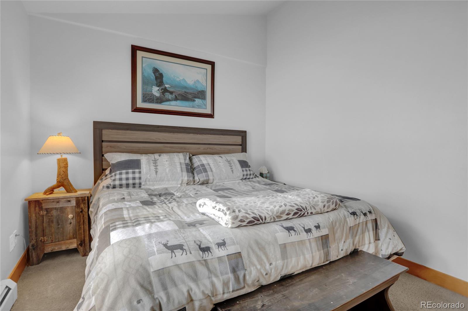 20 County Road 523 Tabernash, CO 80478 - Photo 19 of 32 a bedroom with a bed and a lamp on table