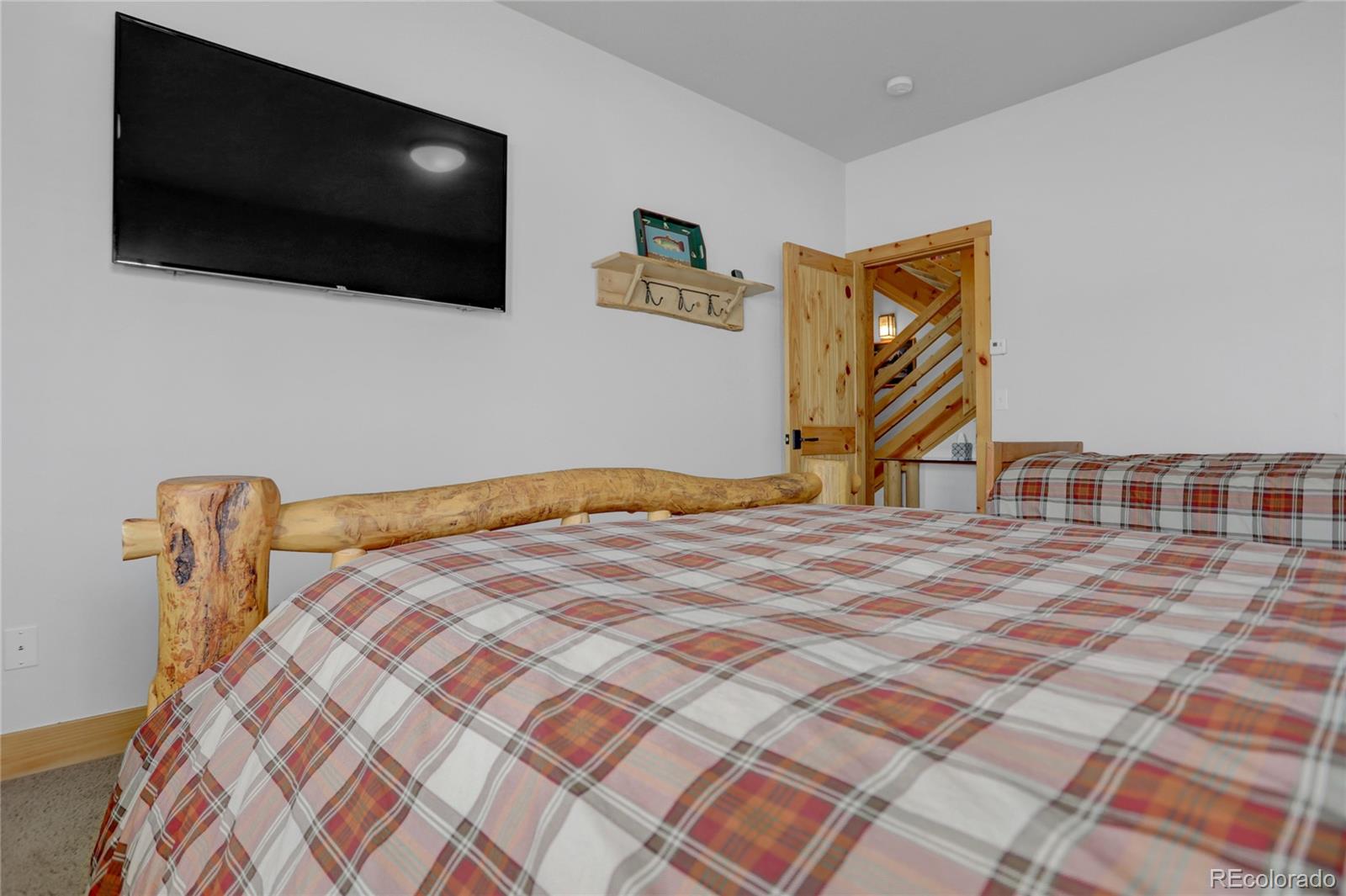 20 County Road 523 Tabernash, CO 80478 - Photo 26 of 32 a bedroom with a bed and a flat screen tv