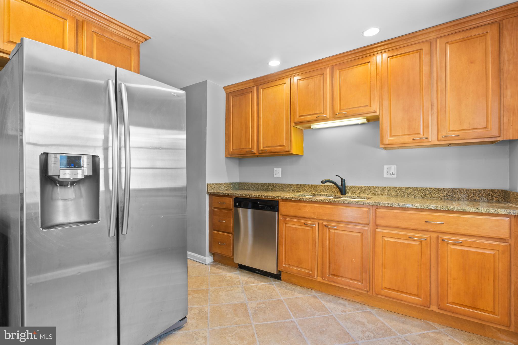 1603 Kirby Road McLean, VA 22101 - Photo 11 of 38 a kitchen with stainless steel appliances granite countertop a refrigerator and a sink