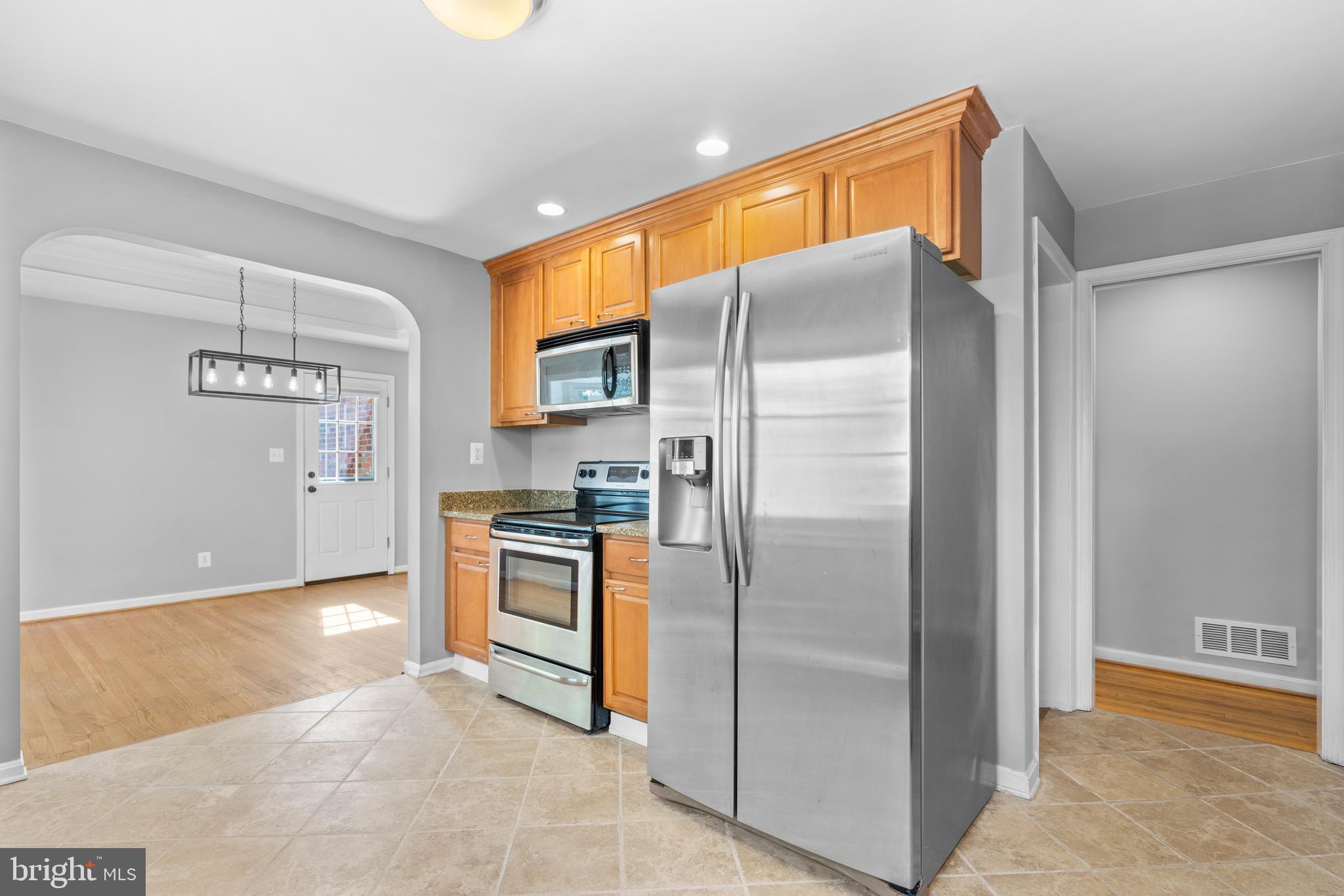 1603 Kirby Road McLean, VA 22101 - Photo 12 of 38 a metallic refrigerator freezer a stove top oven sitting inside of a kitchen