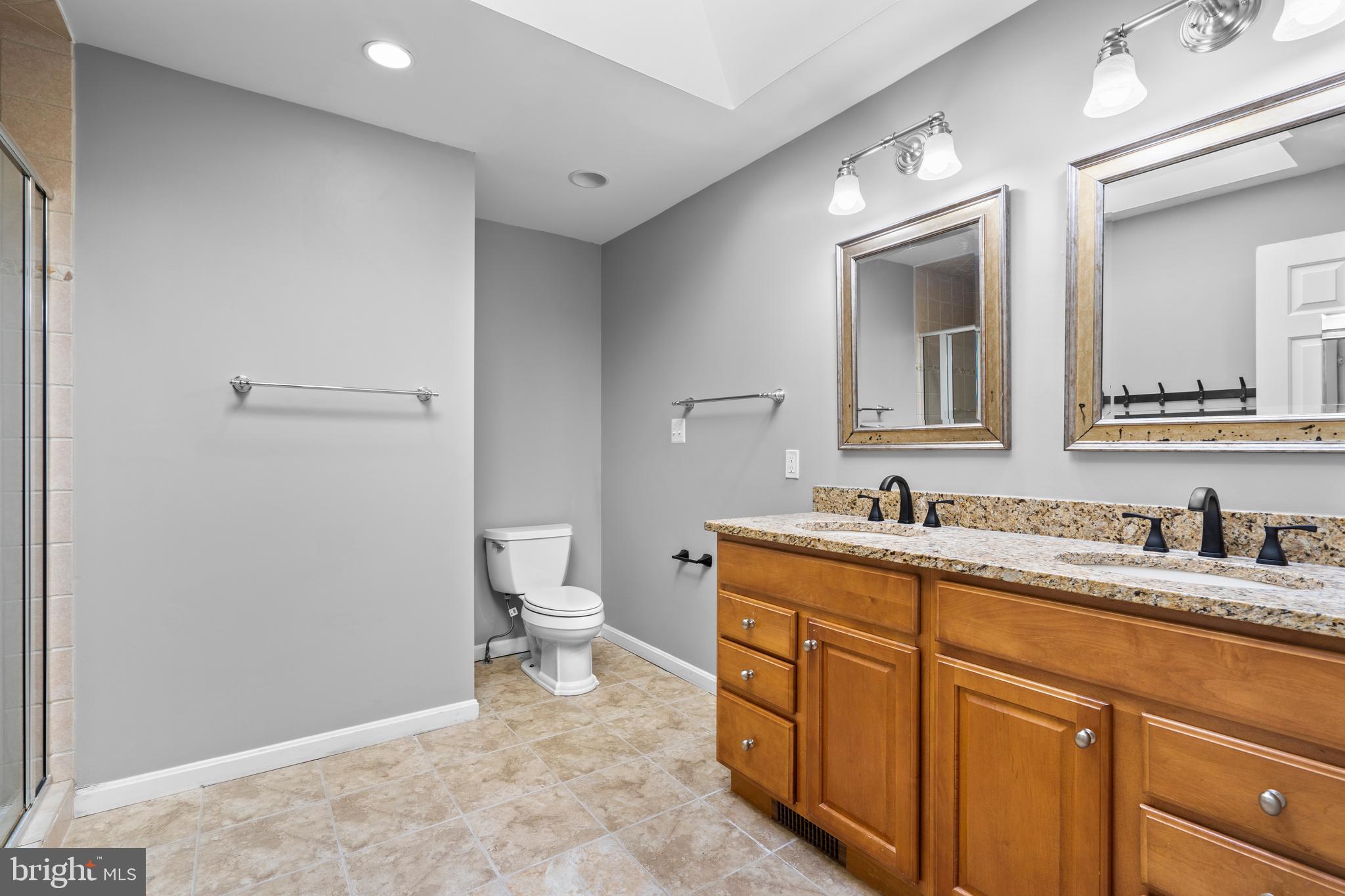 1603 Kirby Road McLean, VA 22101 - Photo 18 of 38 a spacious bathroom with a toilet sink and mirror