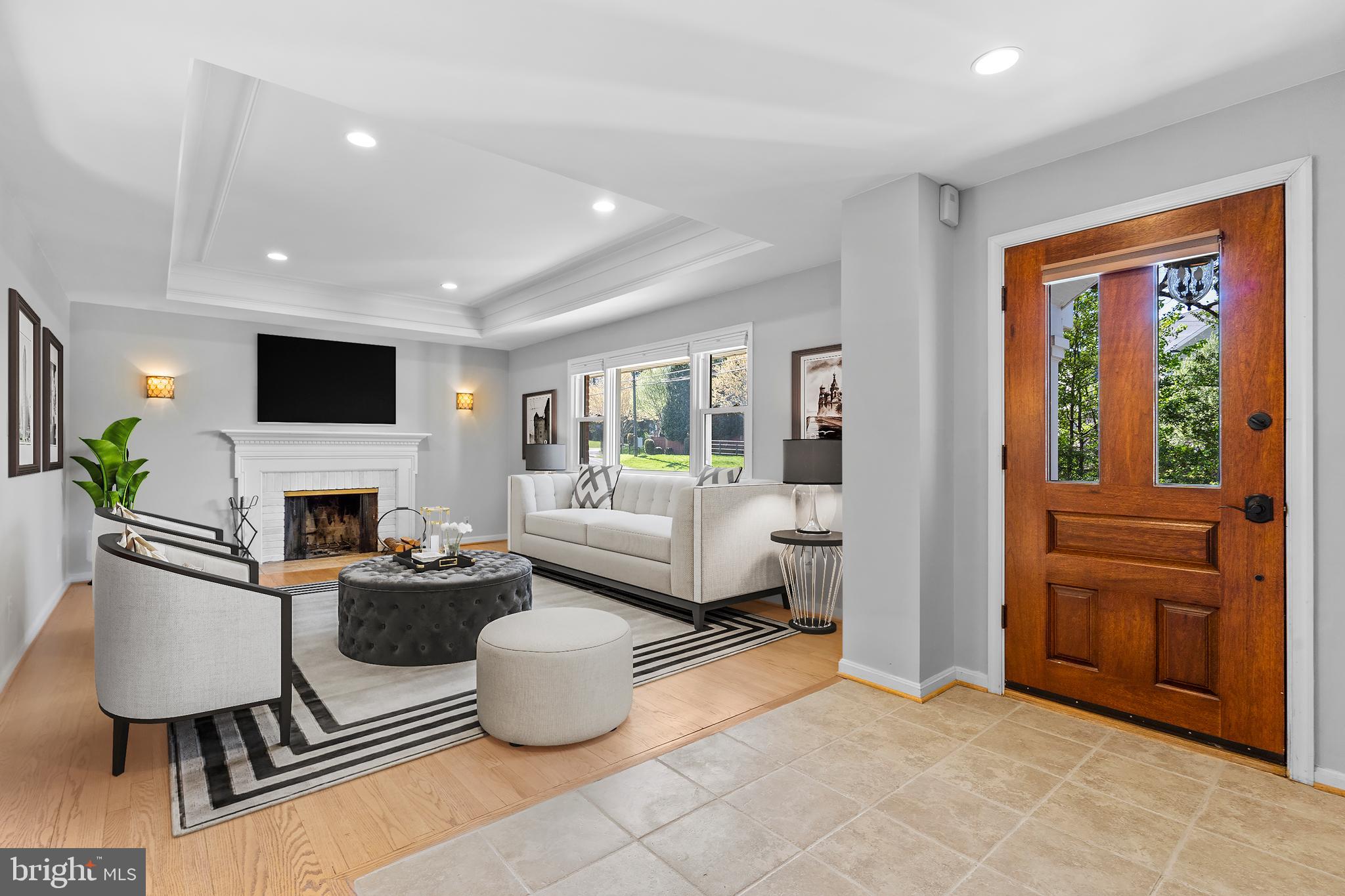 1603 Kirby Road McLean, VA 22101 - Photo 2 of 38 a living room with furniture a fireplace and a flat screen tv