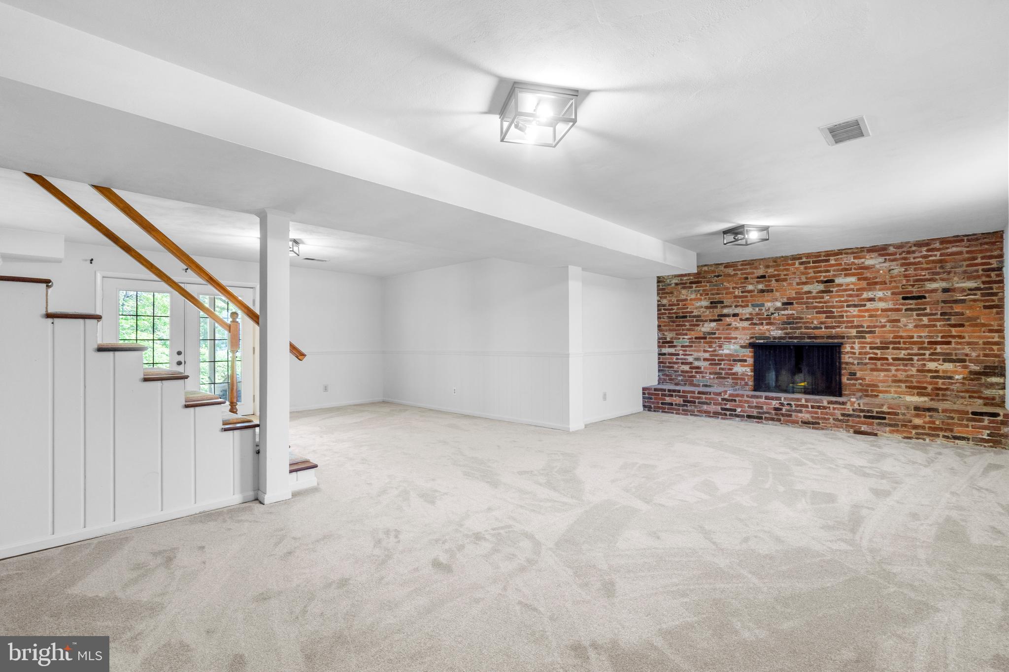 1603 Kirby Road McLean, VA 22101 - Photo 26 of 38 a view of an empty room with stairs and a fireplace