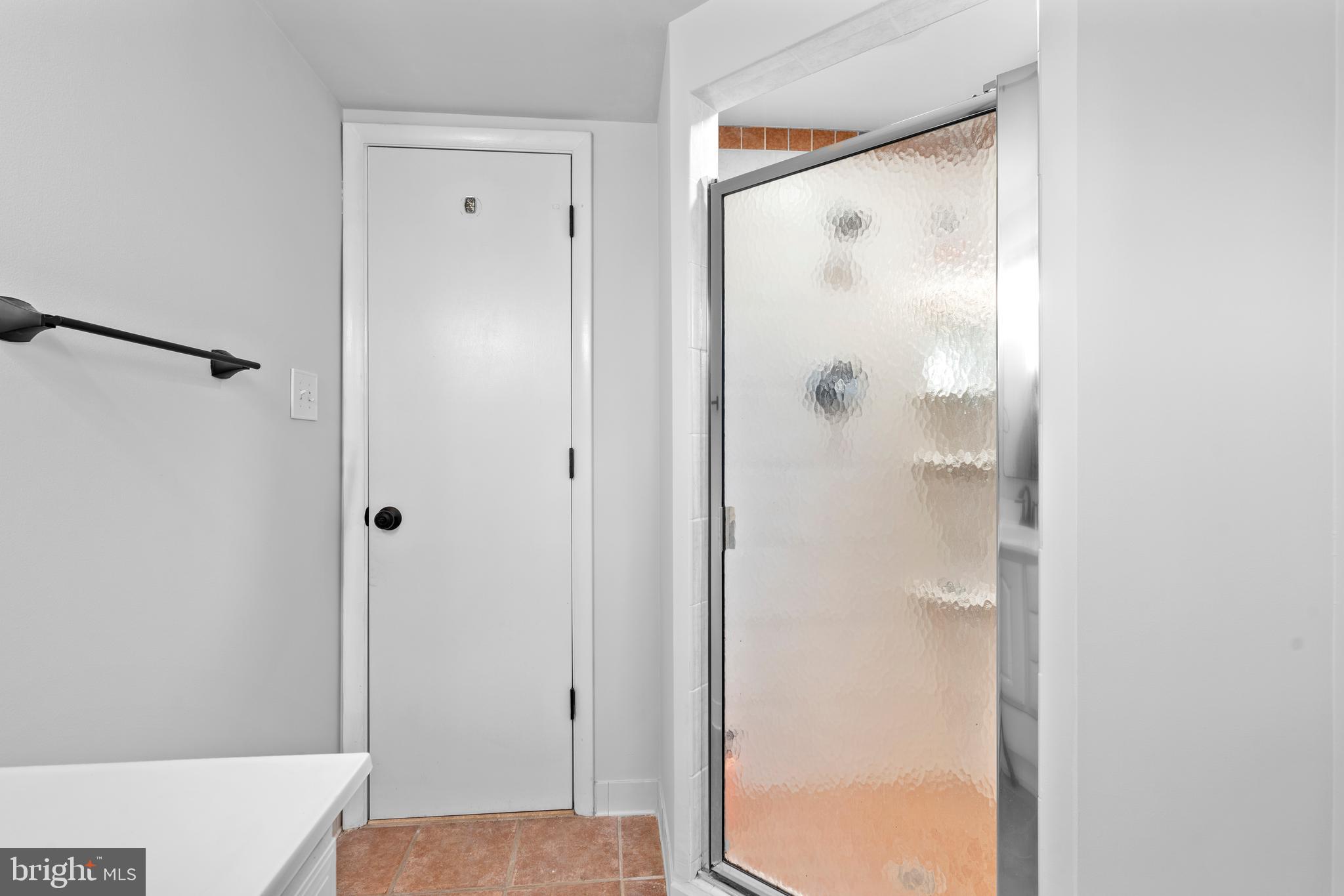 1603 Kirby Road McLean, VA 22101 - Photo 30 of 38 a view of a bathroom with a glass shower door