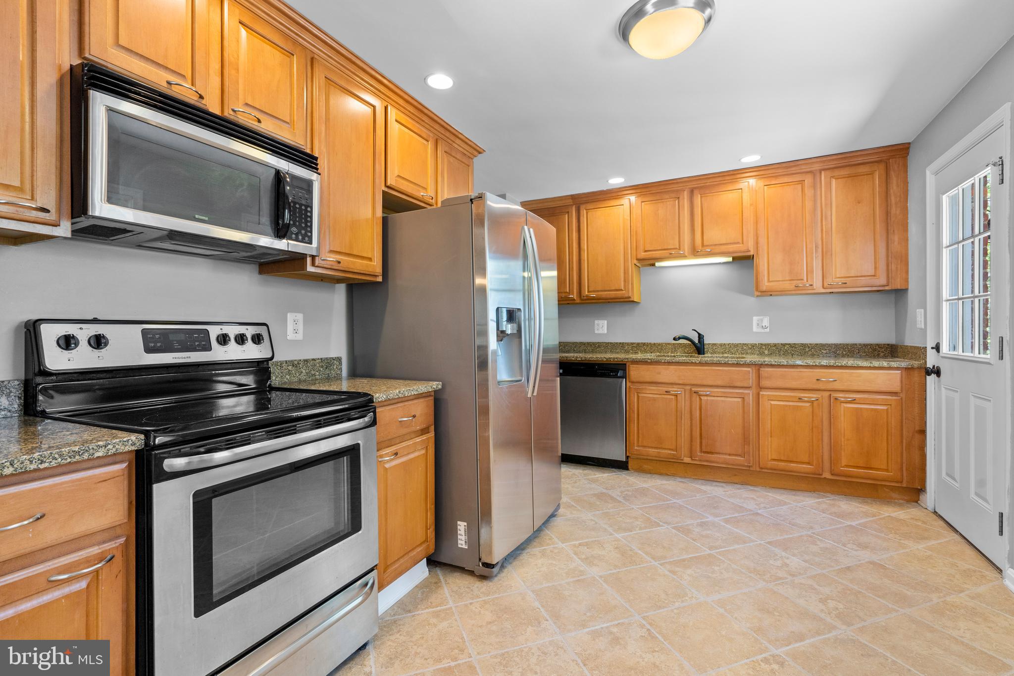 1603 Kirby Road McLean, VA 22101 - Photo 10 of 38 a kitchen with stainless steel appliances a stove a sink and a microwave