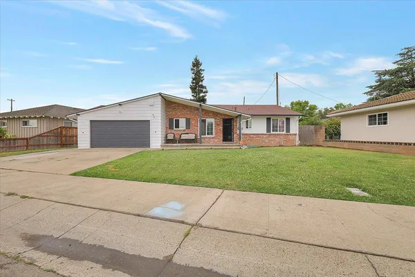 a front view of house with yard and green space