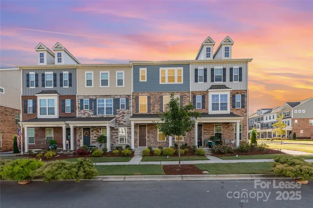 a front view of a residential apartment building with a yard