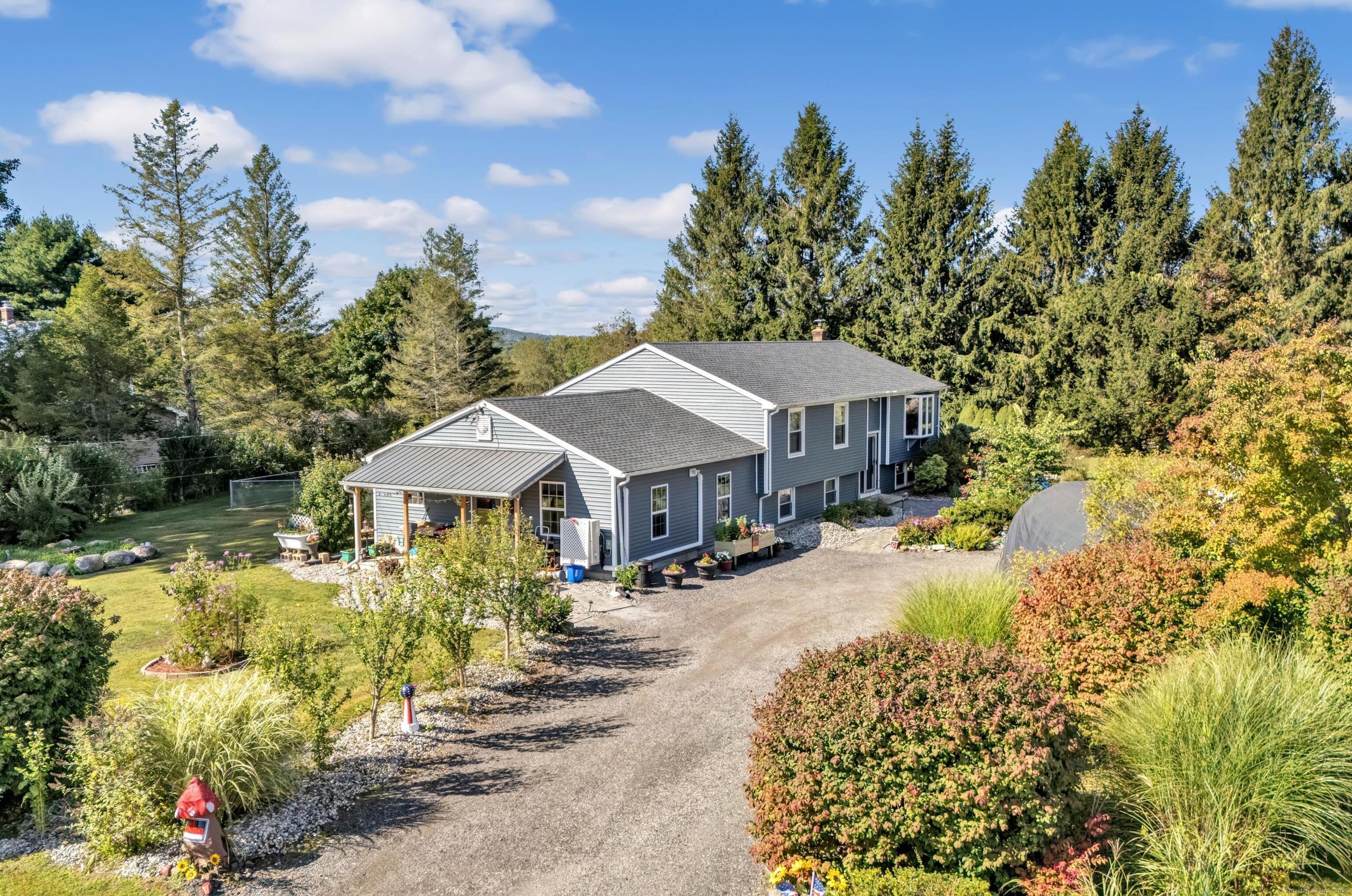 a front view of a house with a yard street and trees