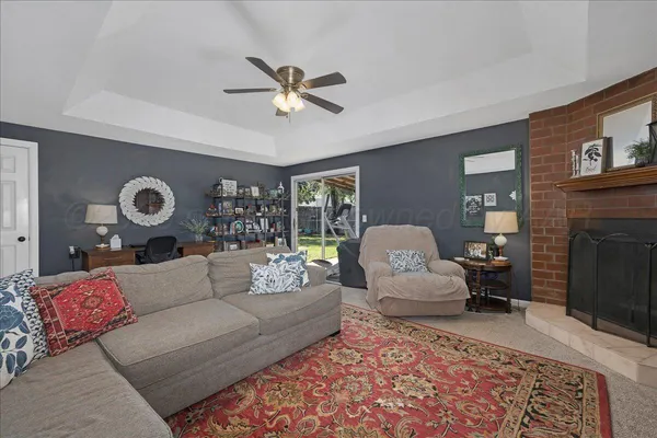 a living room with furniture and a fireplace
