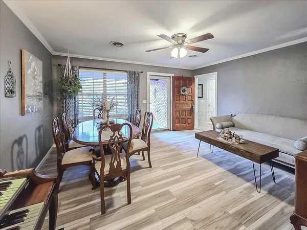 a view of a dining room with furniture window and wooden floor