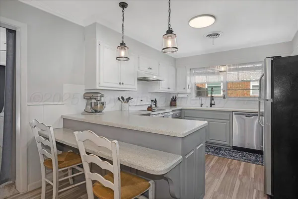a kitchen with a sink window and cabinets
