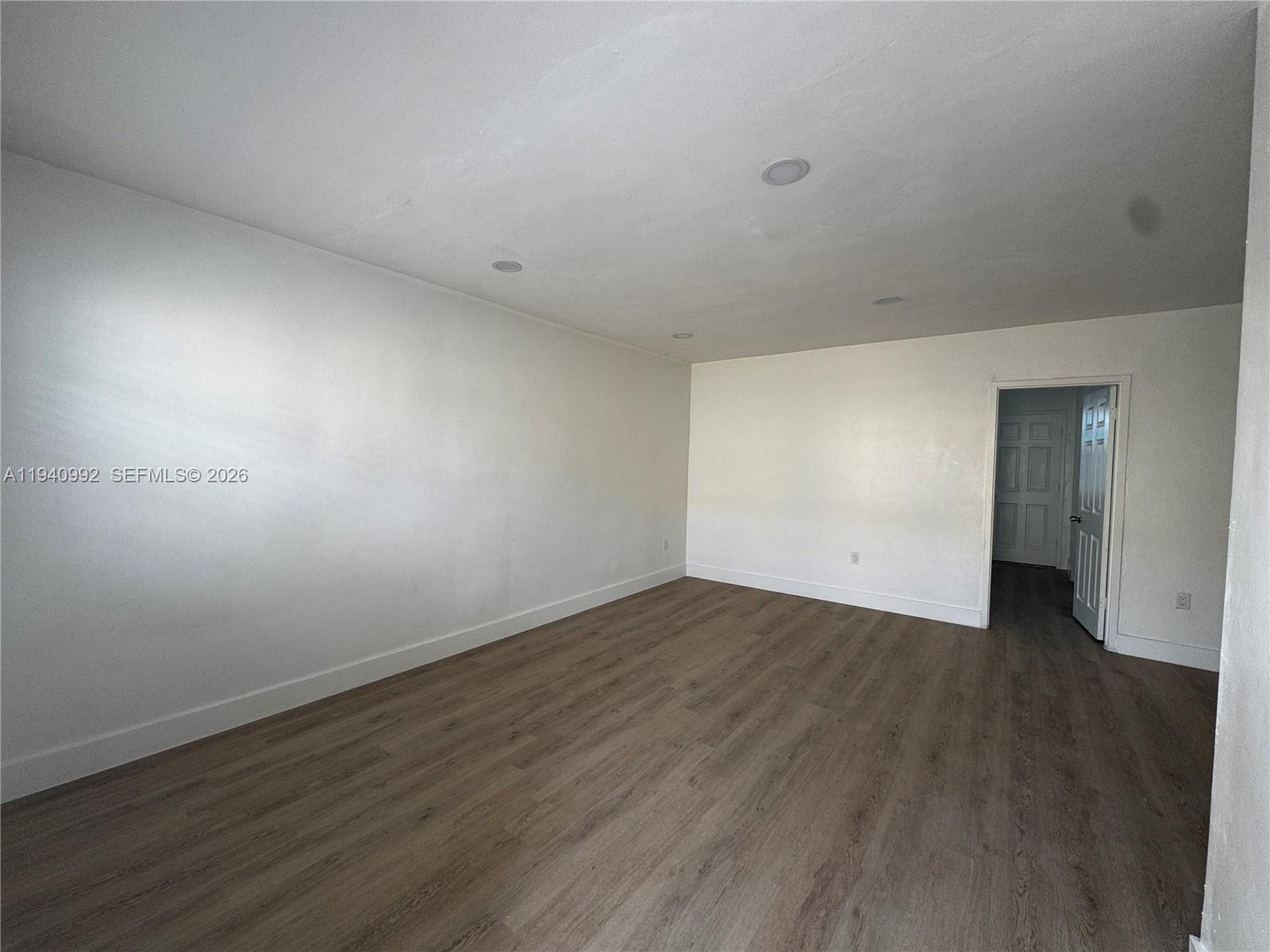 500 13th Street, Unit 10 Miami Beach, FL 33139 - Photo 4 of 12 a view of an empty room with wooden floor and closet