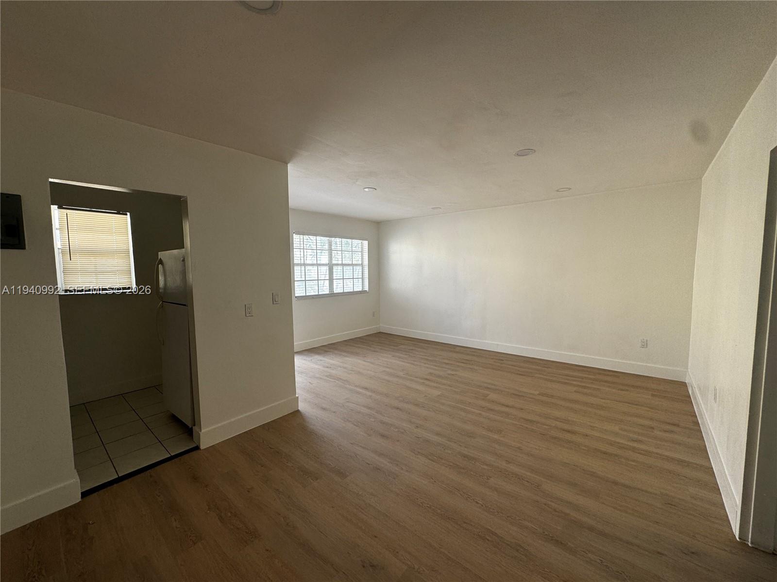 500 13th Street, Unit 10 Miami Beach, FL 33139 - Photo 8 of 12 an empty room with wooden floor and windows