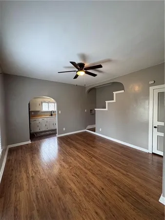 a view of empty room with wooden floor
