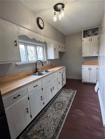 a spacious bathroom with double vanity and a mirror