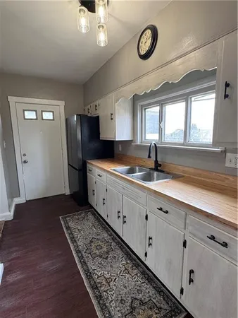 a bathroom with a double vanity sink and mirror
