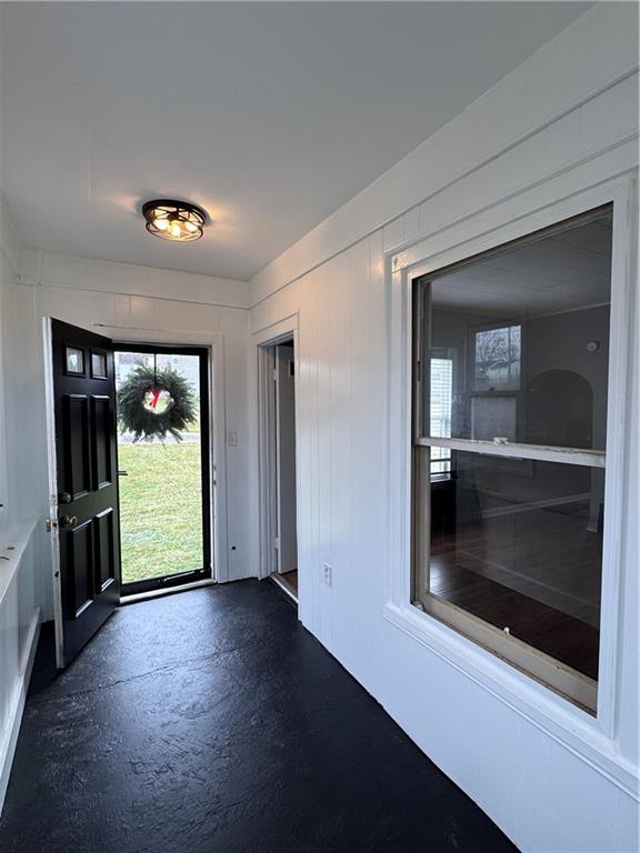 504 Emerson Avenue Farrell, PA 16121 - Photo 8 of 24 an entryway at an empty room with a fireplace and wooden floor
