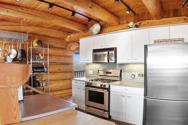 a kitchen with cabinets and stainless steel appliances