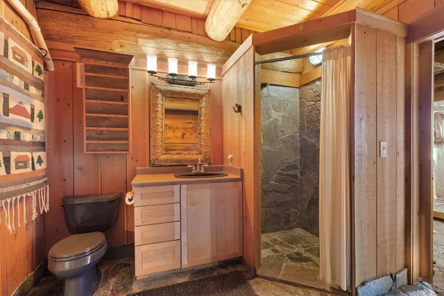 a bathroom with a toilet a sink and shower