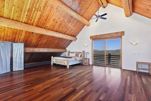 a view of a room with wooden floor and furniture